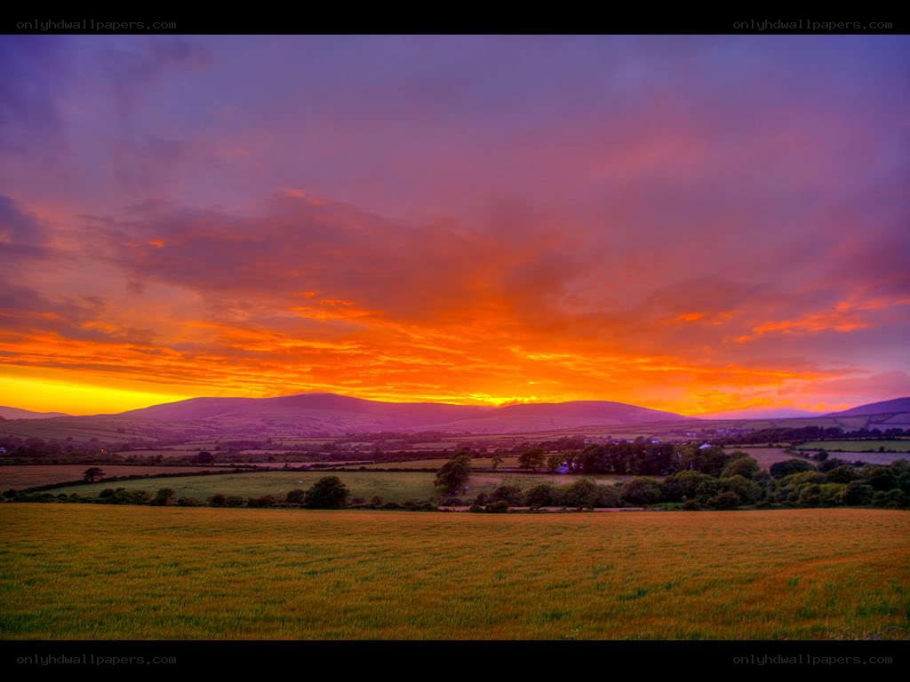 Vibrant sunset over rolling hills