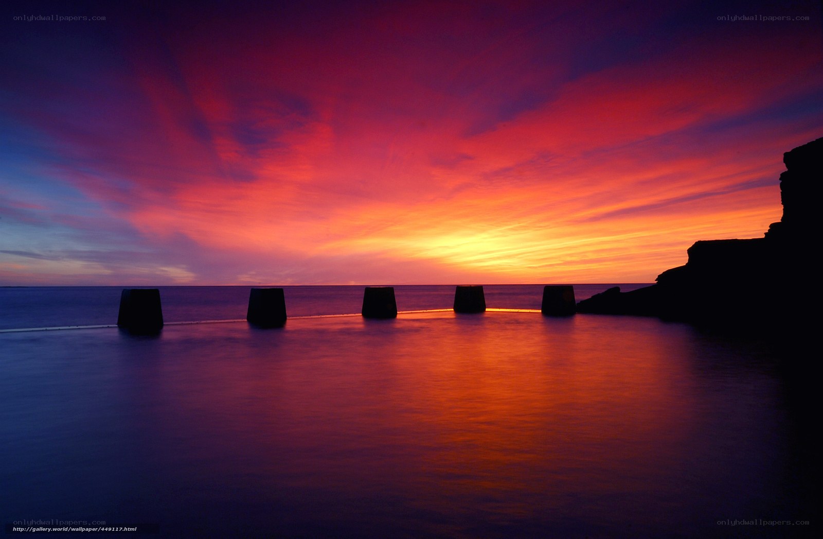 Vibrant sunset over sea wall
