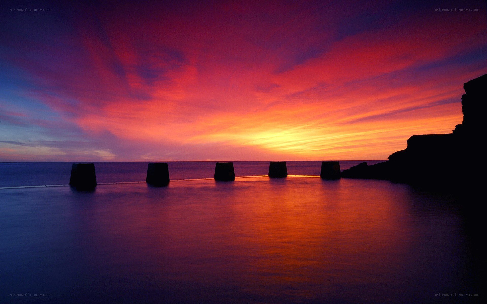 Vibrant sunset over sea wall