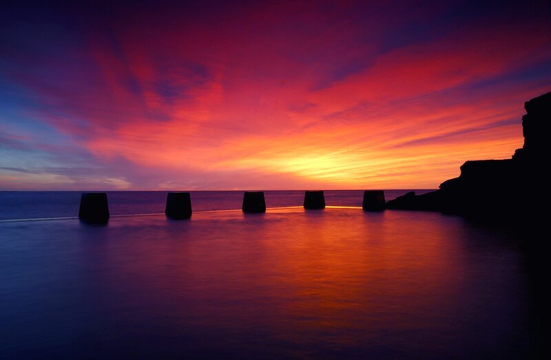 Vibrant sunset over sea wall