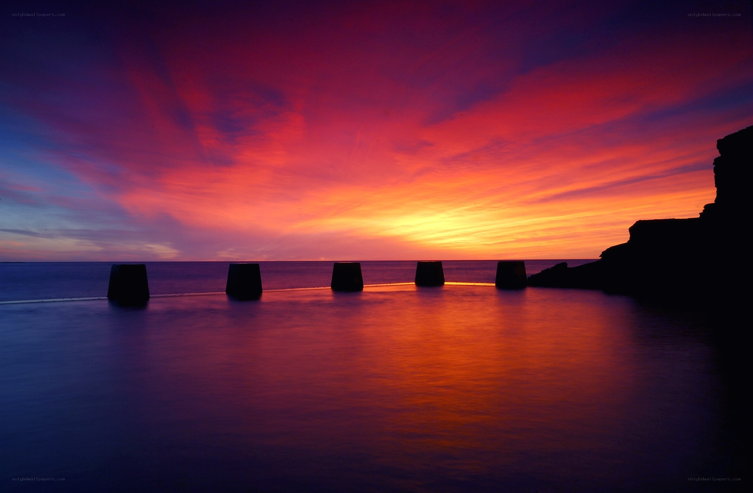 Vibrant sunset over sea wall