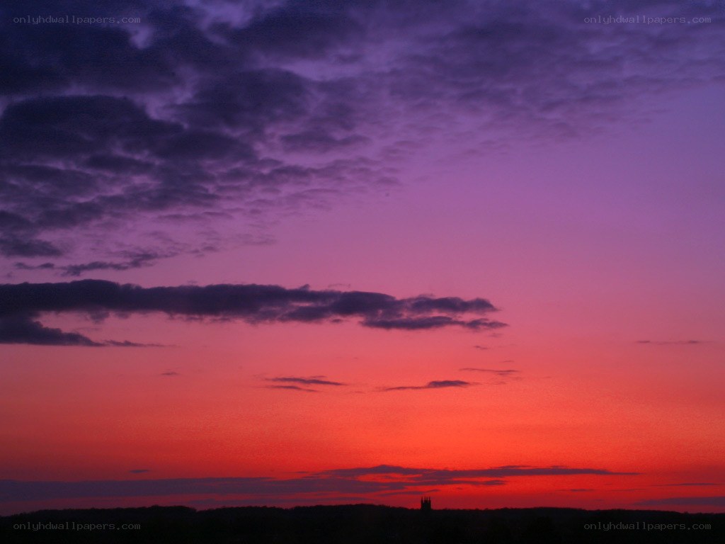 vibrant sunset over silhouetted landscape