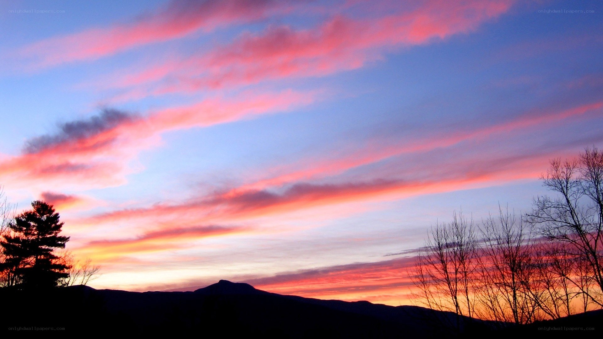 vibrant sunset over silhouetted mountains