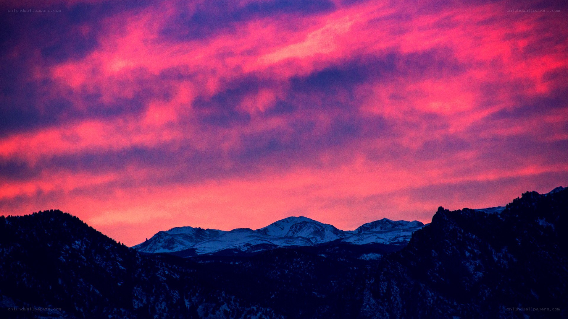 vibrant sunset over snow-capped mountains