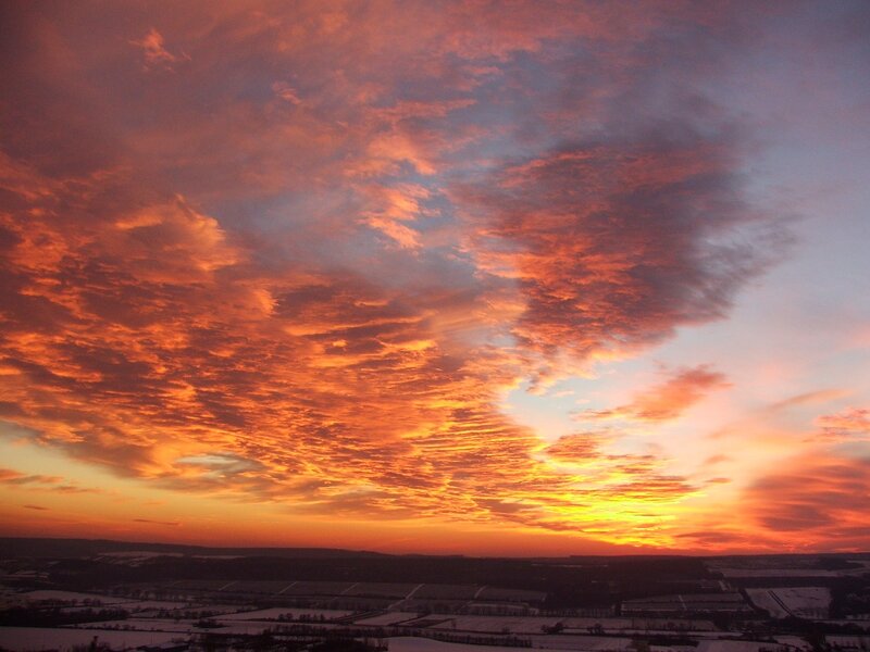 Vibrant sunset over snowy fields