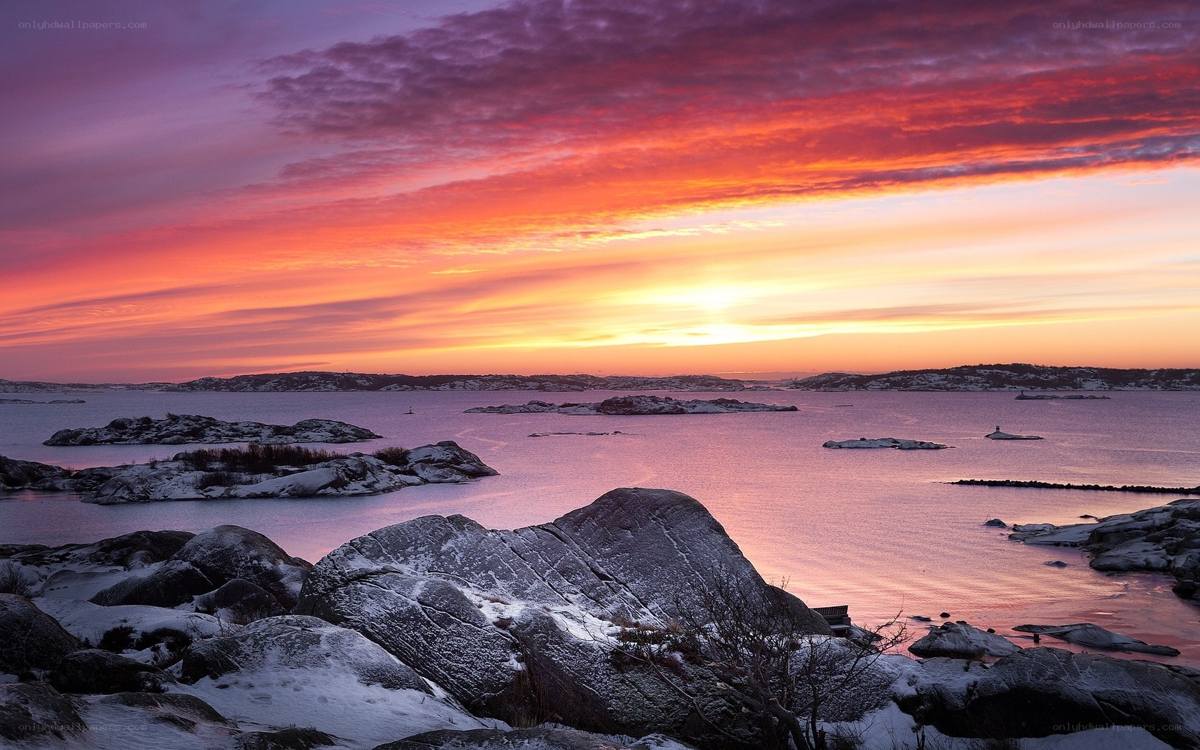 Vibrant sunset over snowy rocks