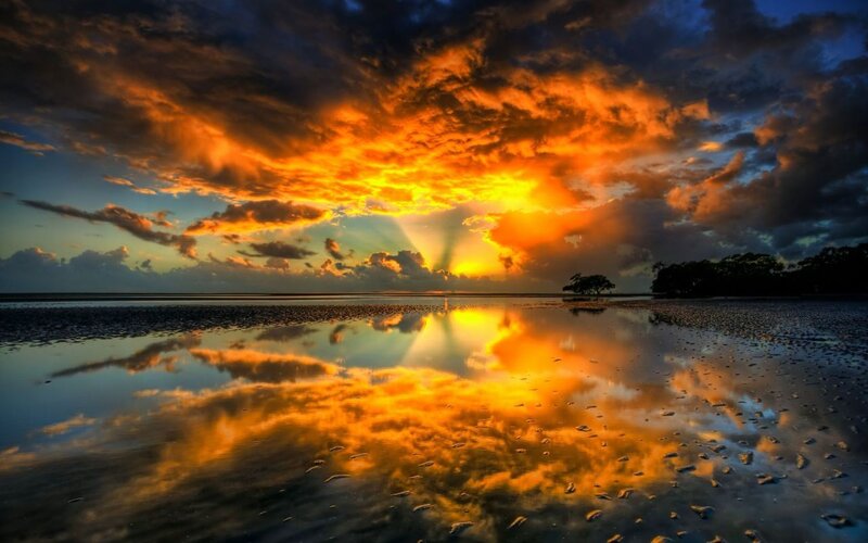 Vibrant sunset over wet beach