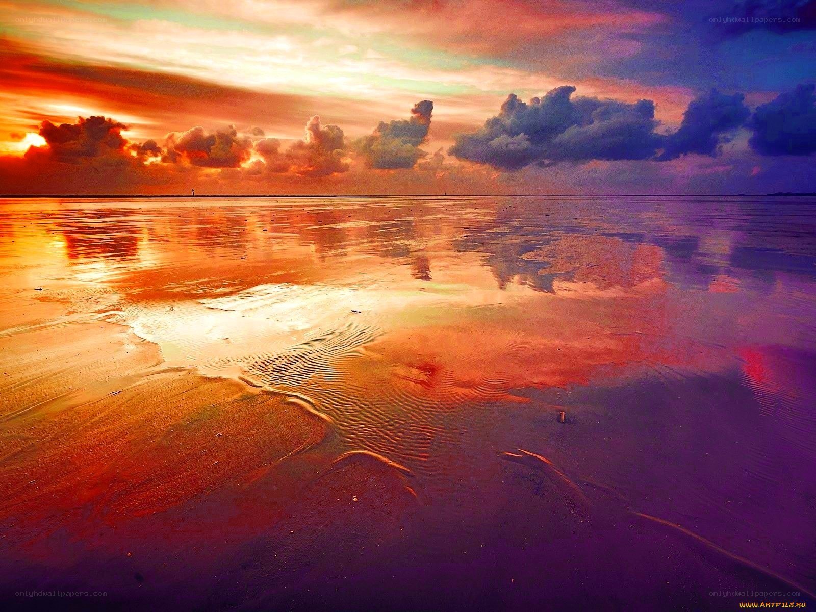 Vibrant sunset over wet sand