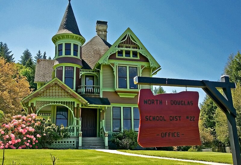 Victorian house with school district sign