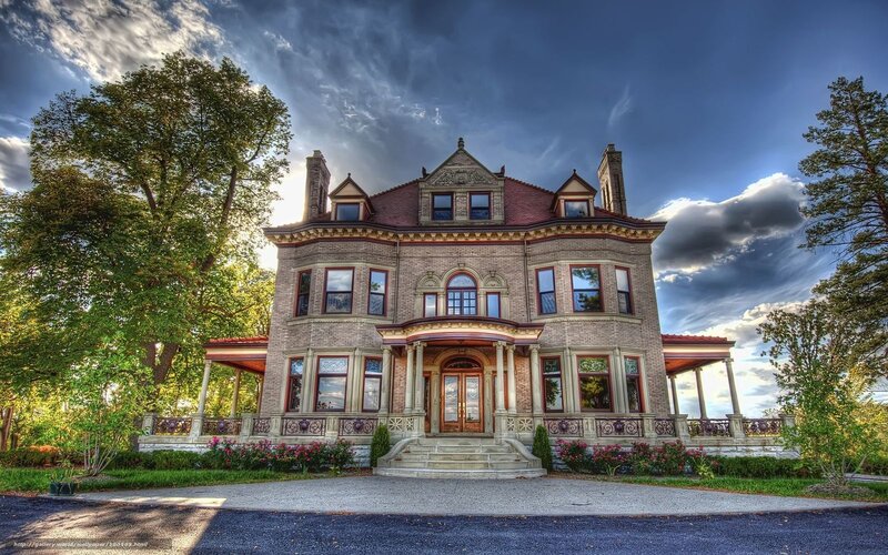 Victorian mansion with dramatic sky