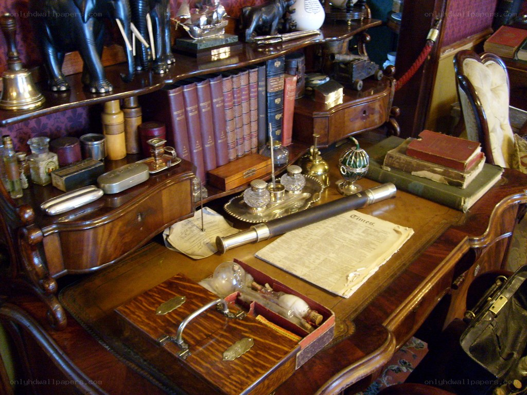 Victorian study desk with books and artifacts