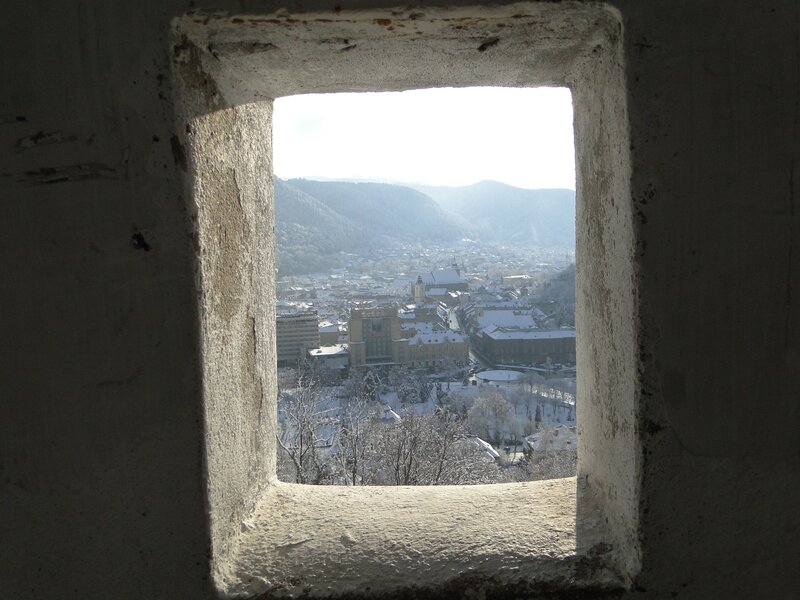 View of snowy town from window