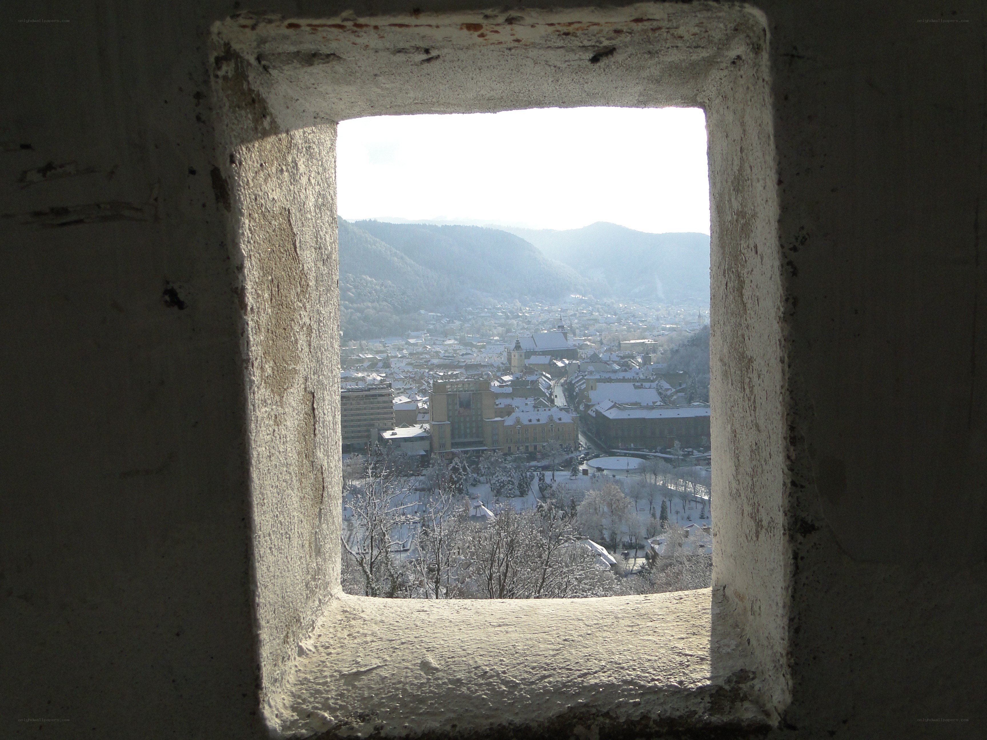 View of snowy town from window