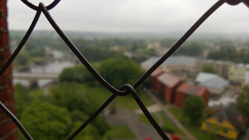 View of town through chain-link fence