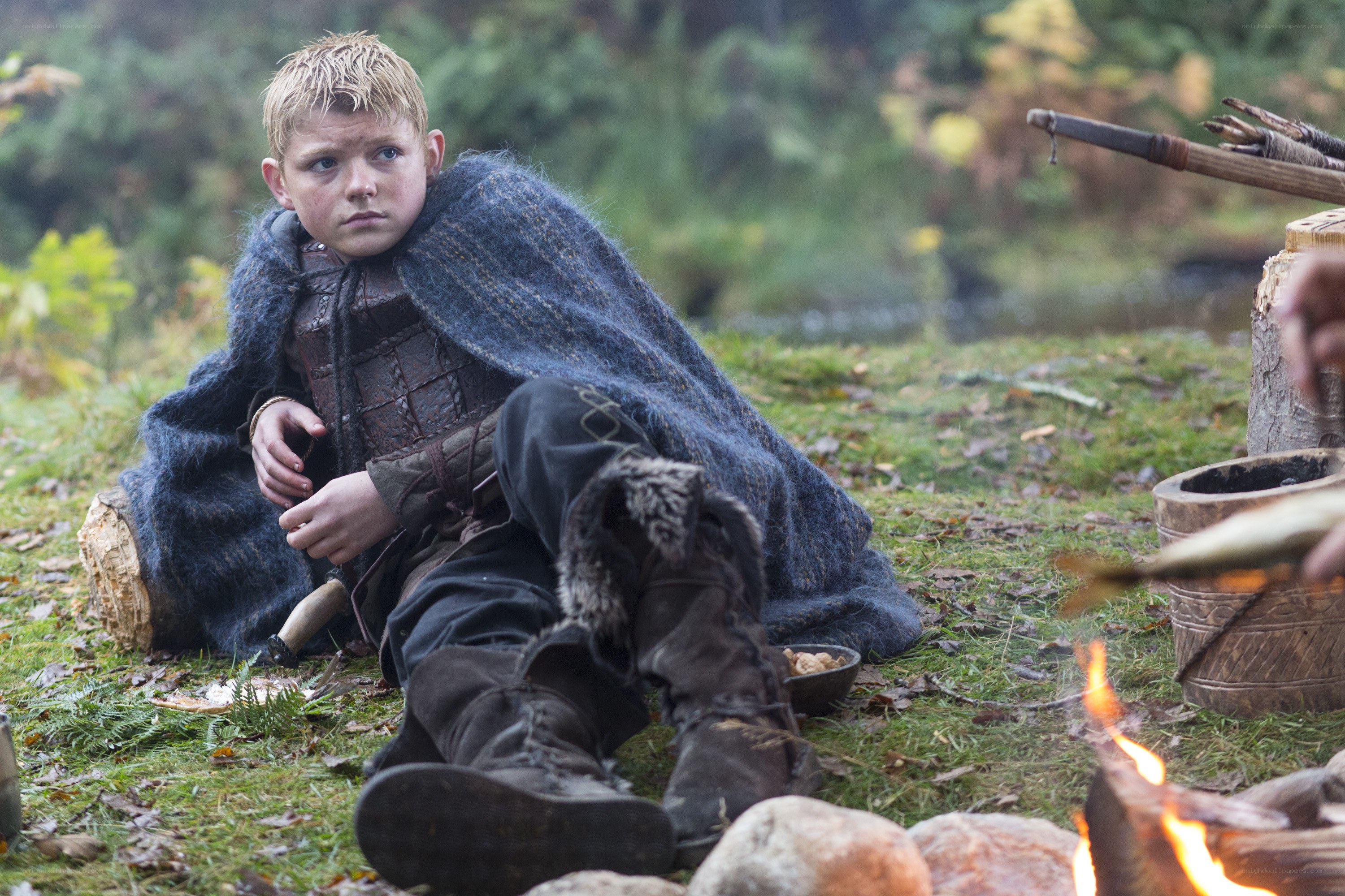 Viking boy by campfire