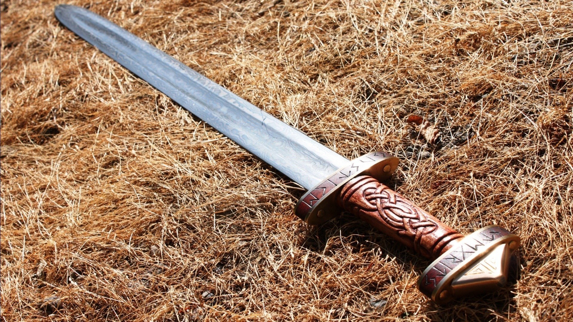 Viking sword on dry grass