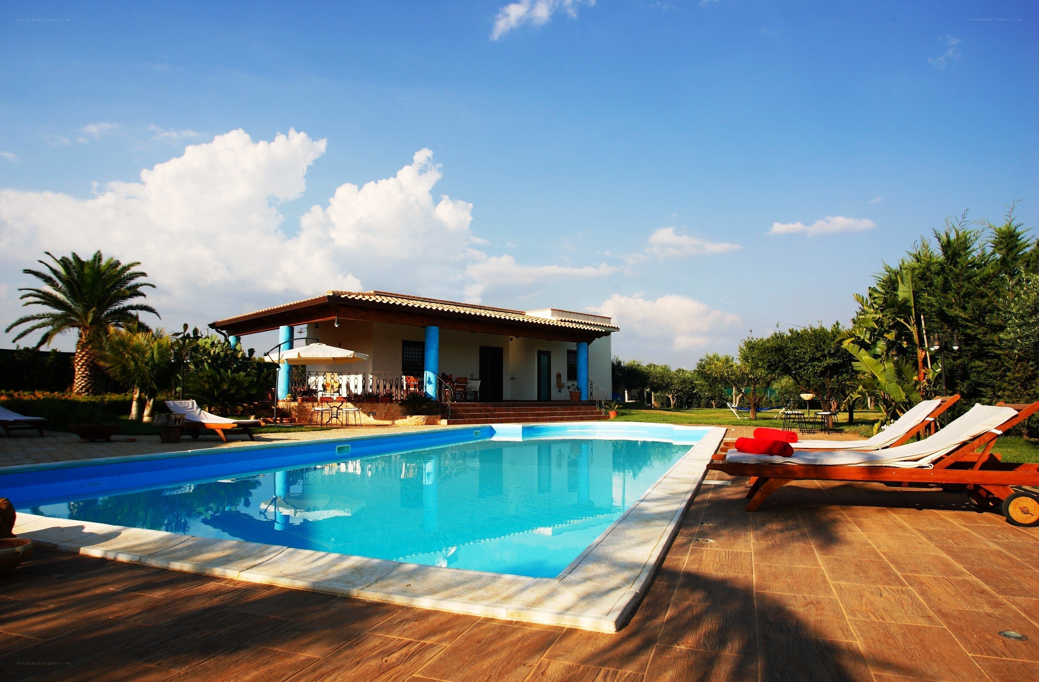 Villa with pool and lounge chairs
