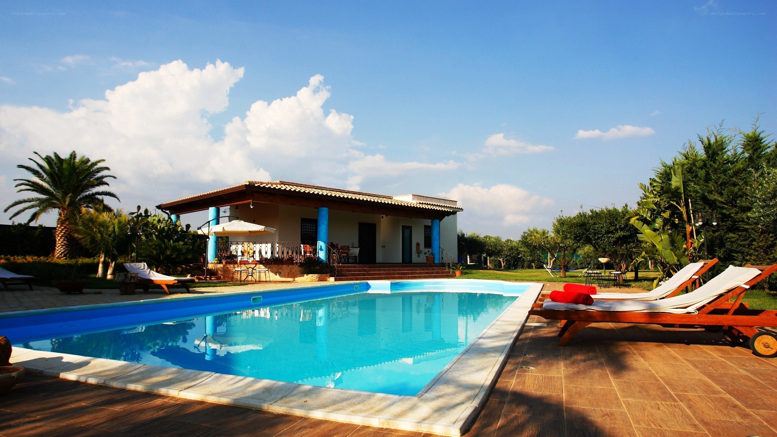 Villa with pool and lounge chairs