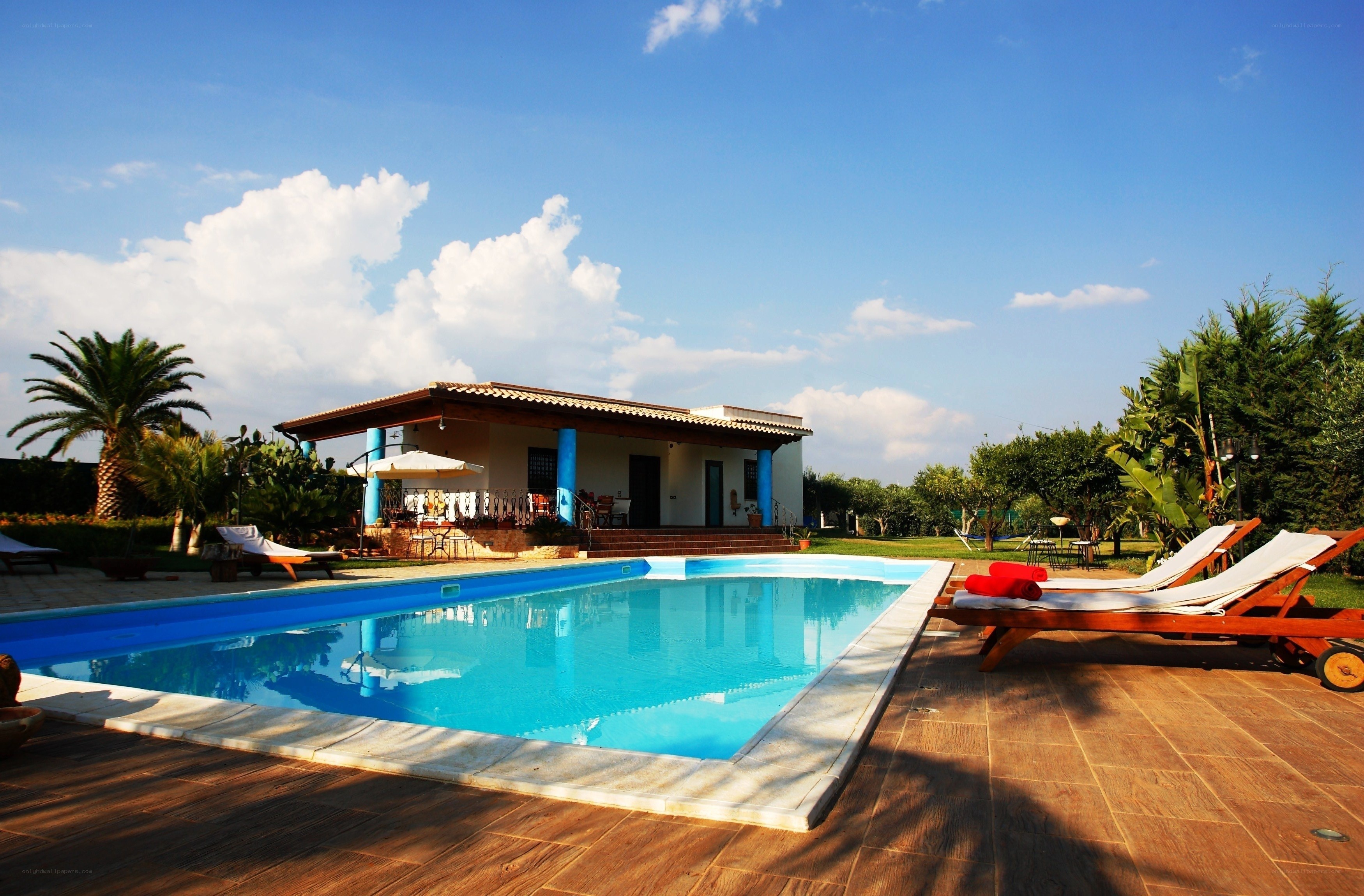 Villa with pool and lounge chairs