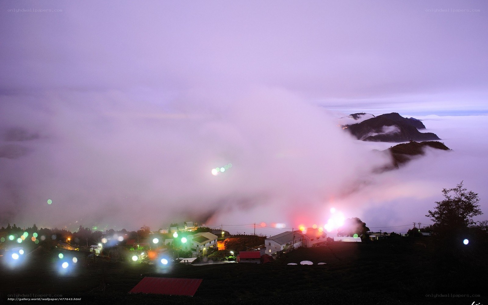 Village above the clouds at night