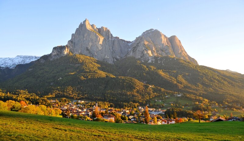 Village at Mountain Base — Green, Serene, Sunset