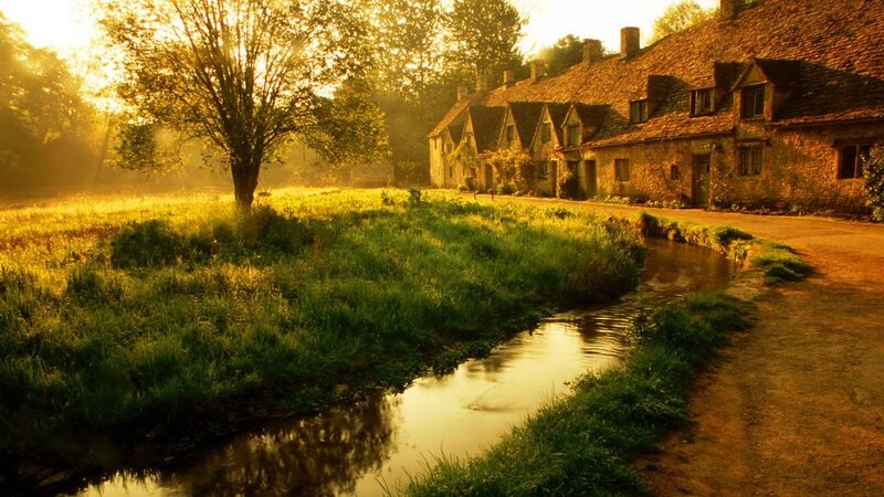 village at sunrise by the stream