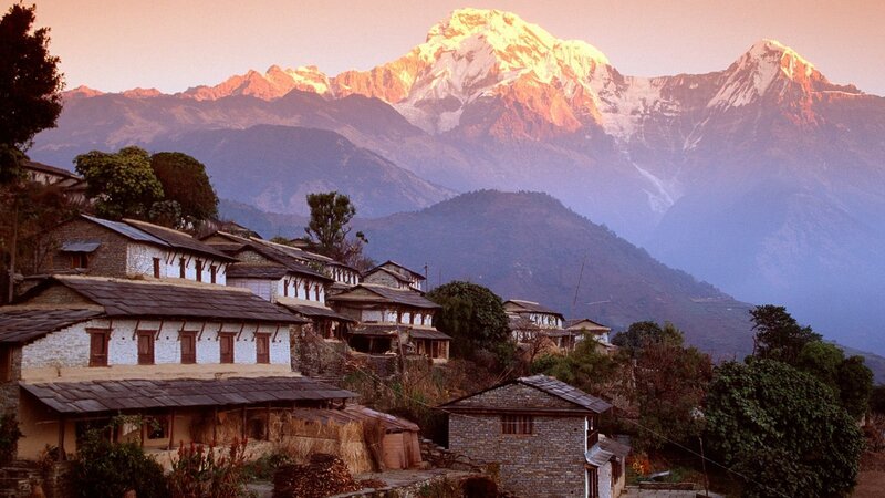 Village at sunrise with Himalayan peaks