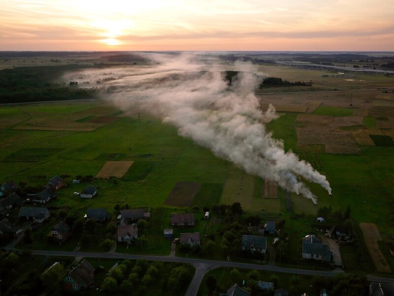 Village at sunrise with smoke