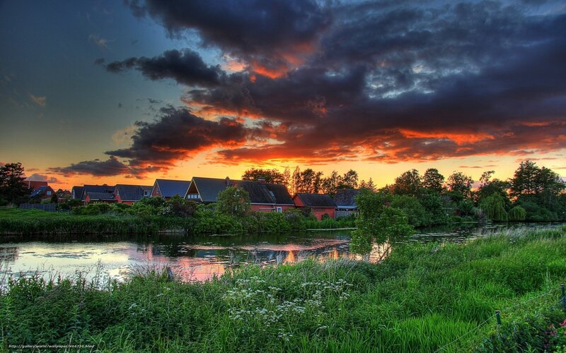 Village at sunset by the river