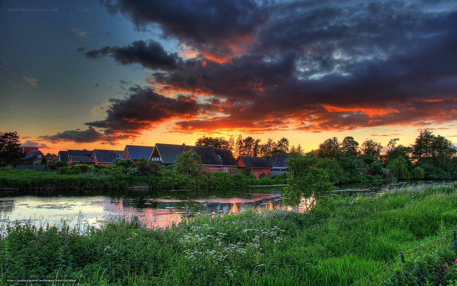 Village at sunset by the river
