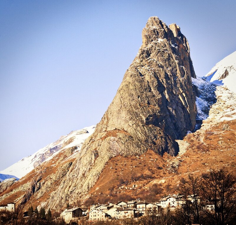 Village at the base of a rocky mountain