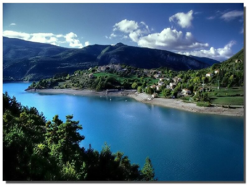 village by a blue lake