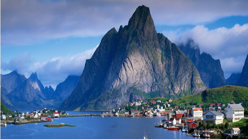 Village by a fjord with mountains