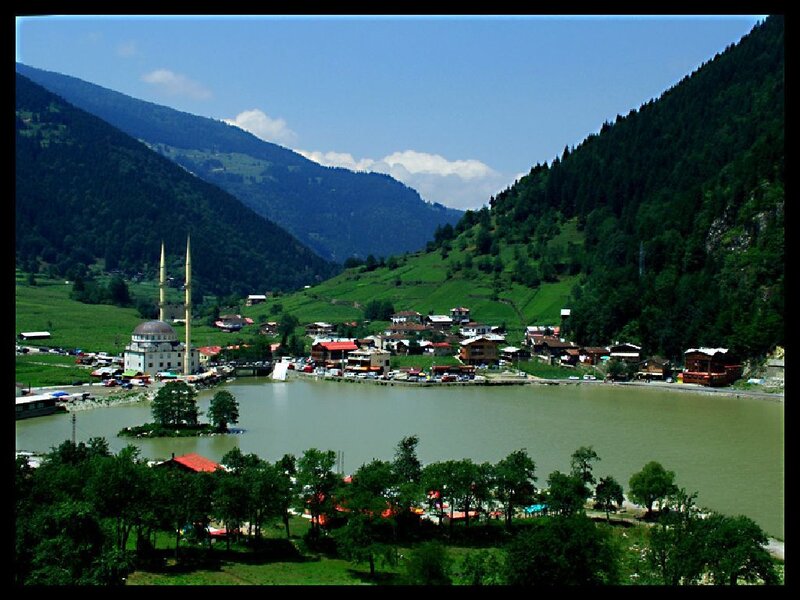 village by a lake in mountains