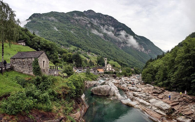 village by a river in the mountains