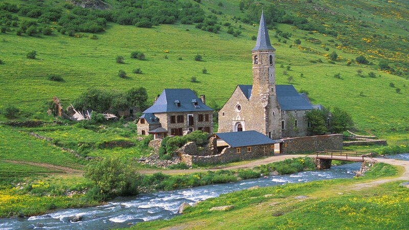 Village by a river with church