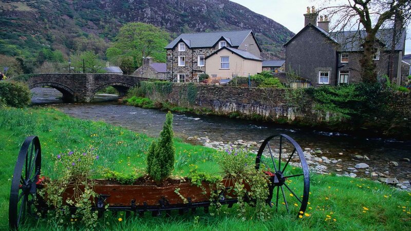 village by a river with stone bridge