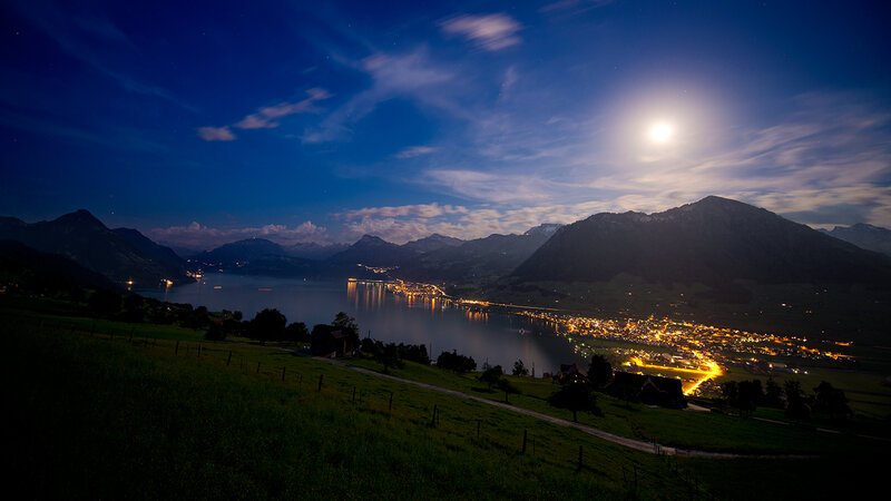 Village by Lake at Night — Blue, Serene, Photograph, Mountains
