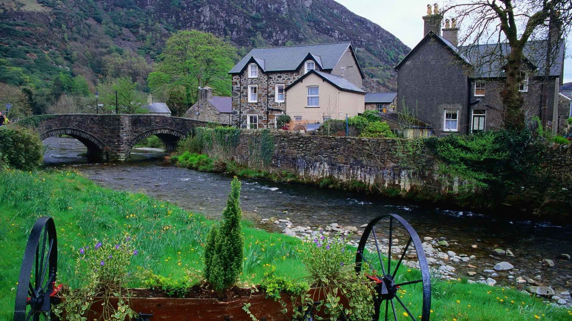 village by river with stone bridge