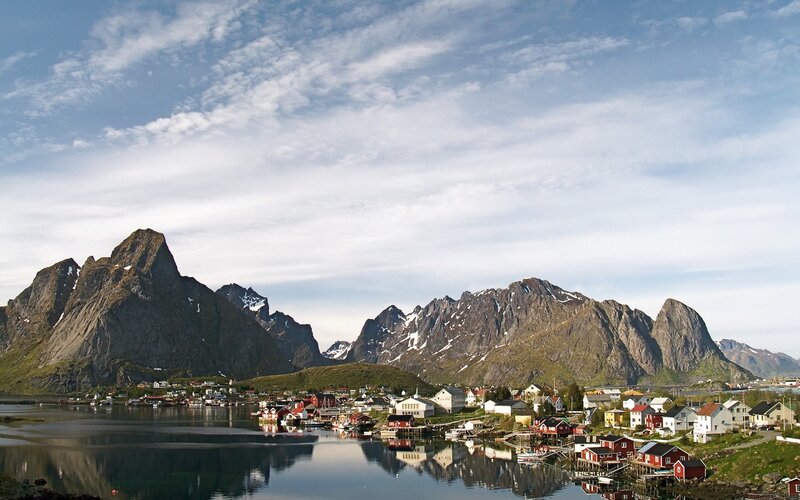 Village by the fjord with mountains