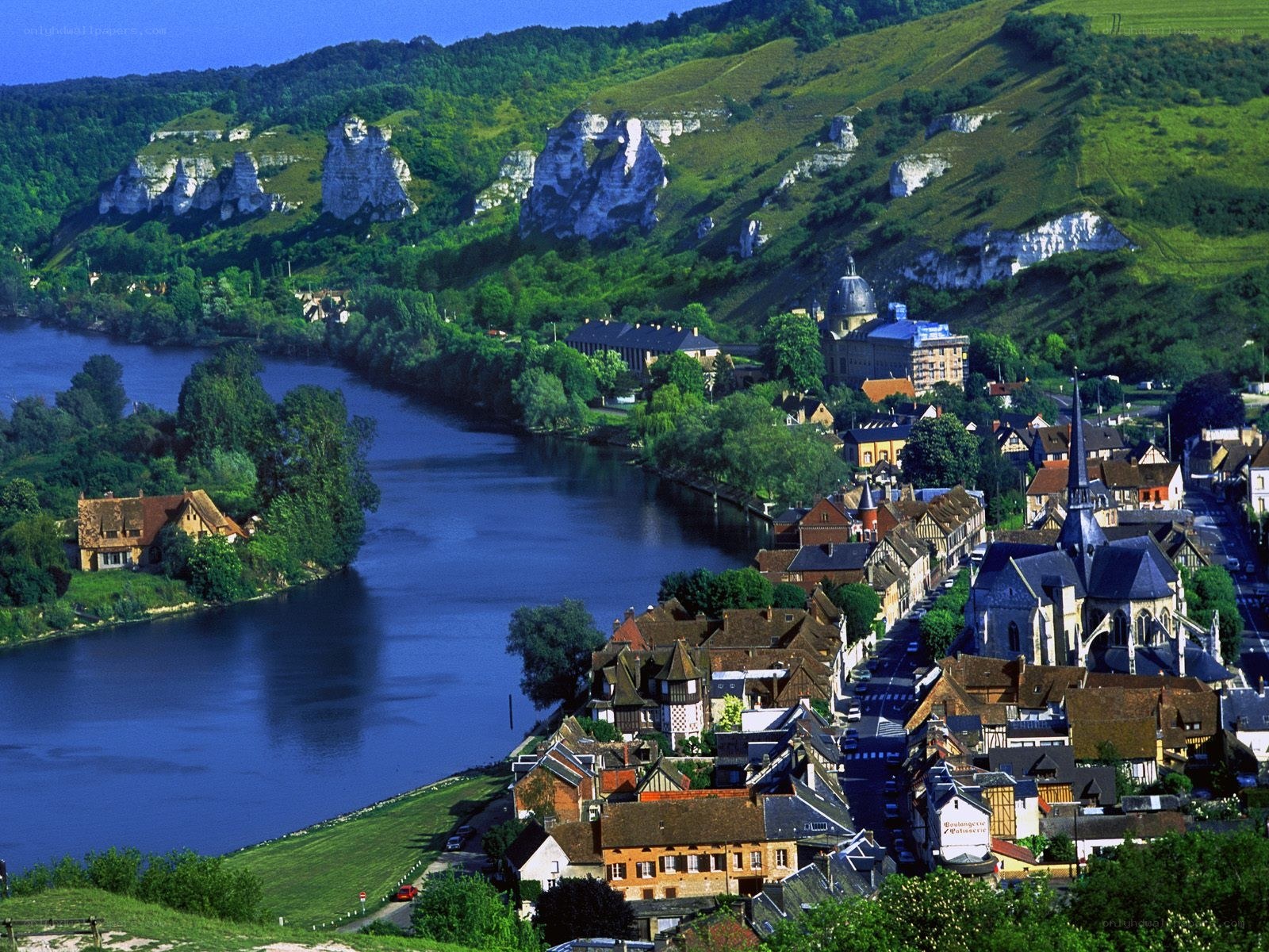 Village by the river and cliffs