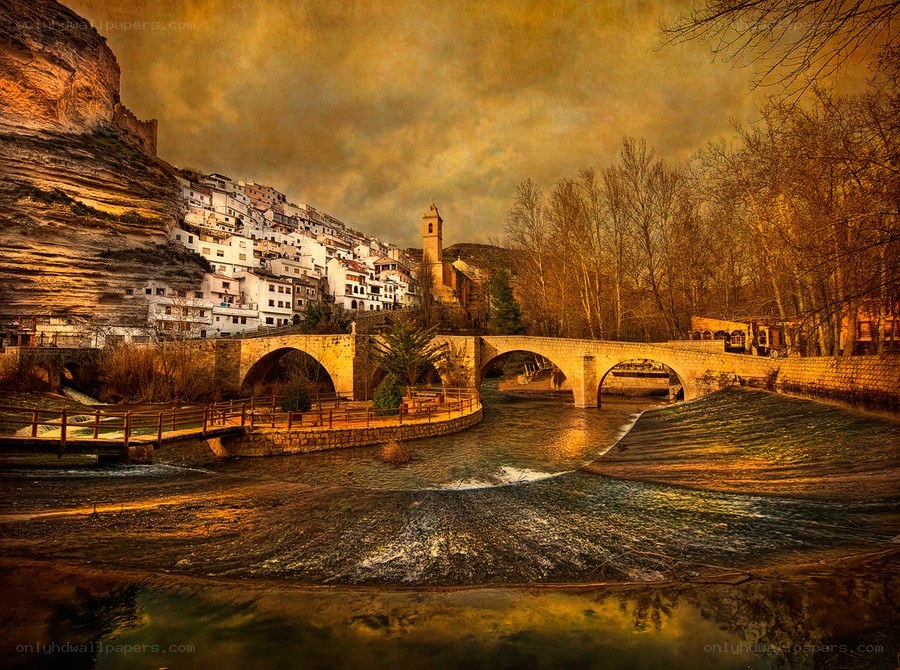 Village by the river at sunset