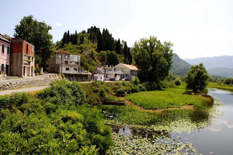 Village by the river with hilltop castle