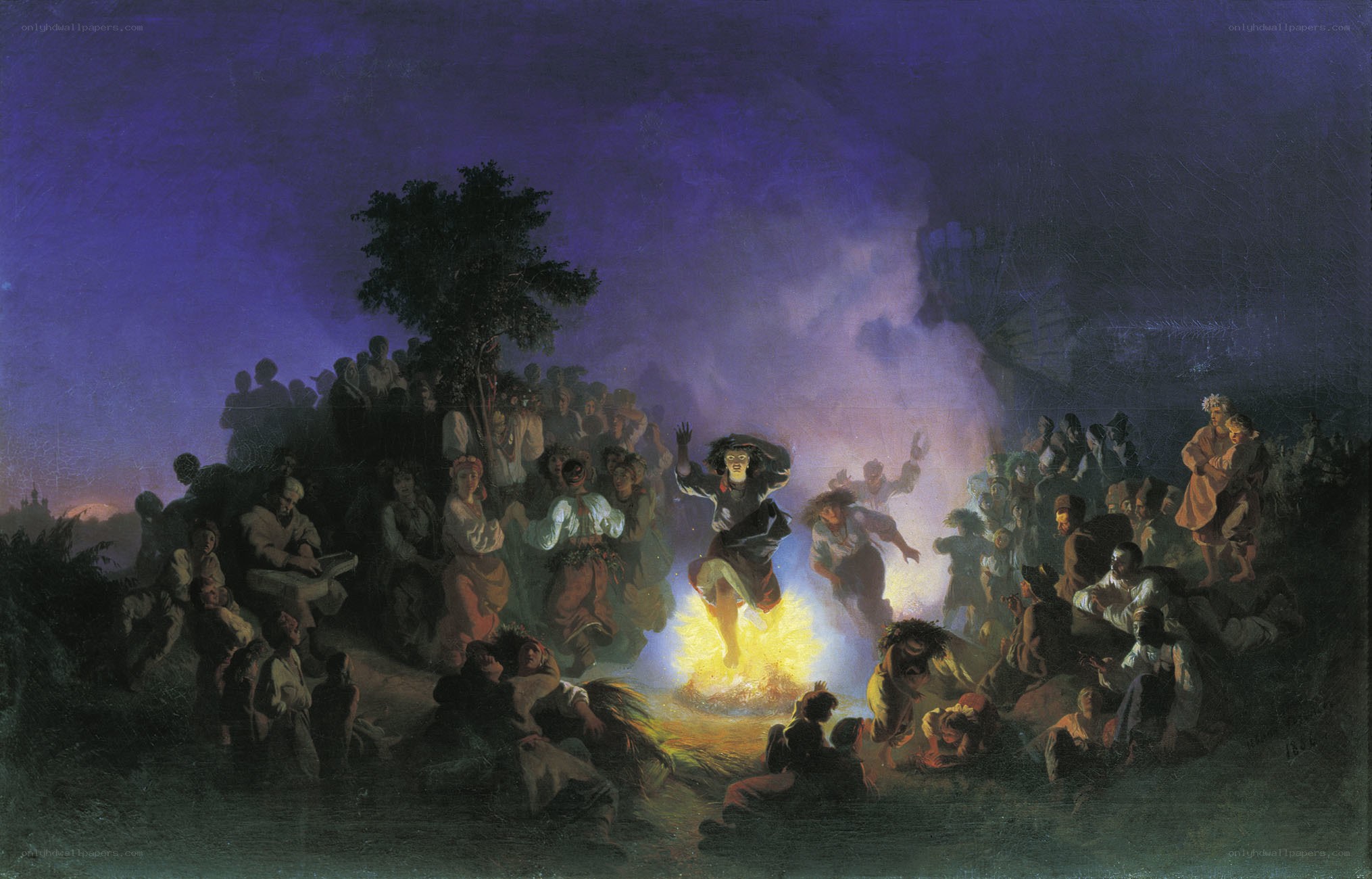 Village gathering around bonfire