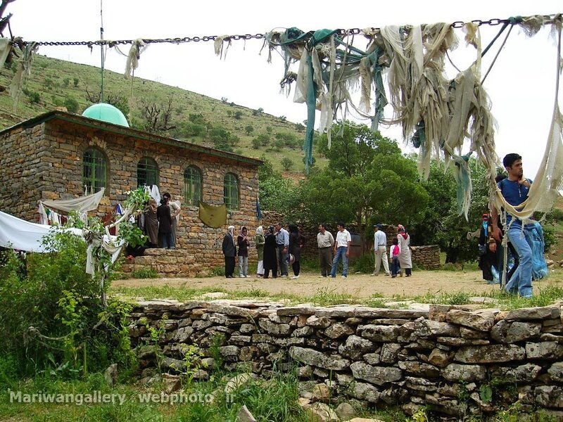 Village gathering near stone building