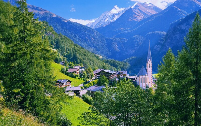 Village in Alpine Valley — Green, Serene, Afternoon, Photograph, Mountains, Church, Trees, Buildings