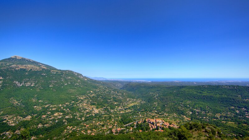 Village in green valley with sea view