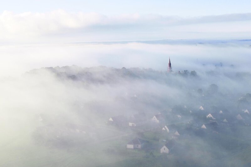 Village in morning fog