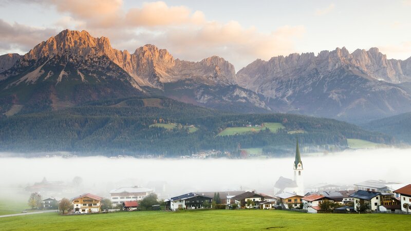 Village in mountain valley at sunrise