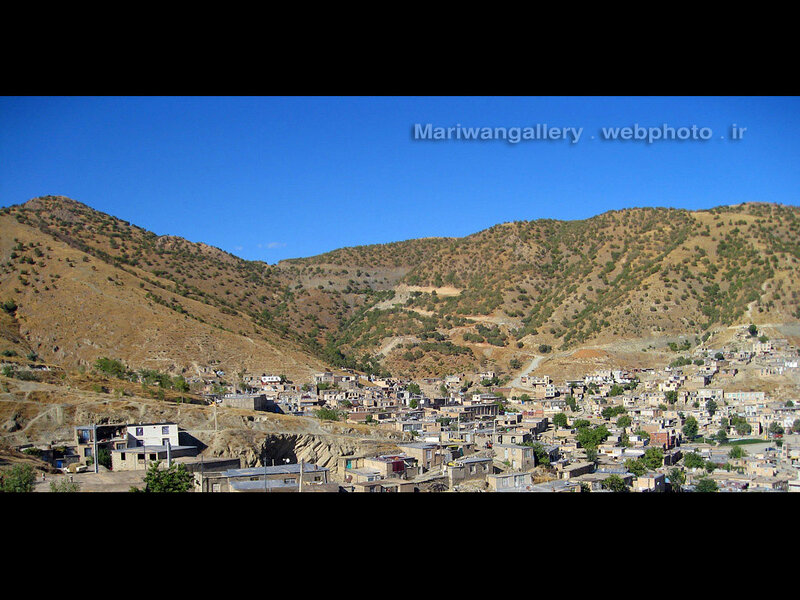 Village in Mountain Valley — Blue, Serene, Afternoon, Photograph, Mountains, Buildings, Trees